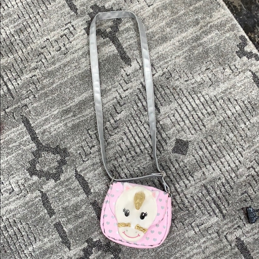 A pink unicorn hang bag with hearts